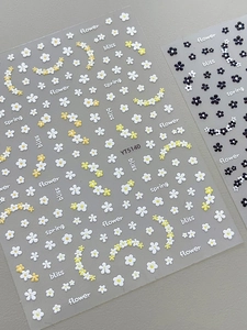 Macro detail of YT5140 3D embossed flower nail stickers with floral patterns and text