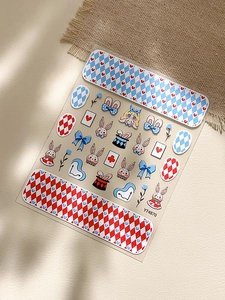 Detailed view of Alice in Wonderland rabbit nail art stickers with argyle patterns