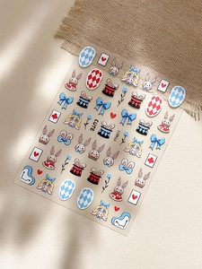 Detail of embossed Alice in Wonderland nail stickers with cute rabbit and card motifs