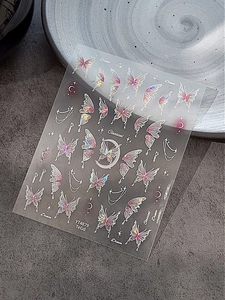 Macro detail of laser butterfly nail stickers with crescent moons and stars pattern