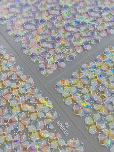 Detail of 3D floral nail art stickers with iridescent glitter and purple flower designs