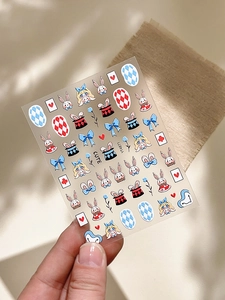 Detail shot of cute Alice in Wonderland themed nail stickers with rabbits and playing cards