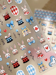 Detail of embossed Alice in Wonderland nail stickers featuring rabbits and poker cards