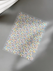 Detailed macro view of iridescent floral nail art stickers with holographic laser finish
