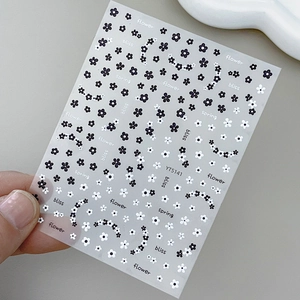 Floral nail stickers featuring black and white daisies with text patterns on sheet YT5141