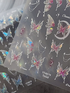Macro detail of laser holographic butterfly nail stickers showing aurora shell reflections