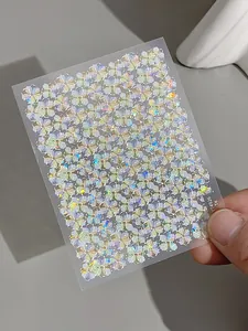 Holographic laser nail stickers with iridescent five-petal floral patterns on sheet