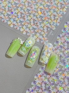 Macro detail of floral nail art stickers with 3D butterflies and sparkling rhinestones