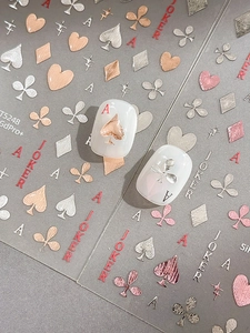 Detail of rose gold and silver poker card nail stickers with 3D embossed texture