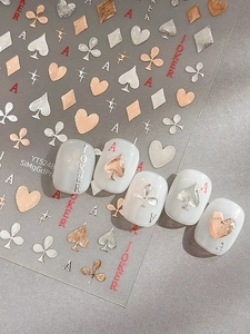 Macro view of metallic rose gold and silver poker nail art stickers with 3D embossed texture