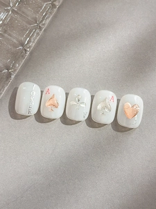 Macro detail of poker themed press-on nails with 3D gold spades and Joker patterns