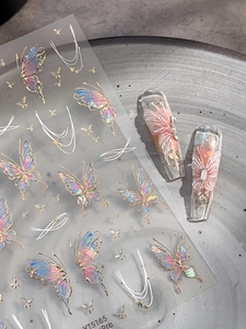 Macro shot of iridescent aurora butterfly nail stickers and long press-on nail art detail