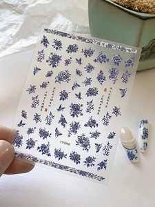Detail of blue and white porcelain nail art stickers with peonies and butterfly designs