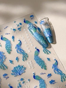 Detail of peacock nail stickers with glitter feathers and Chinese cloud patterns