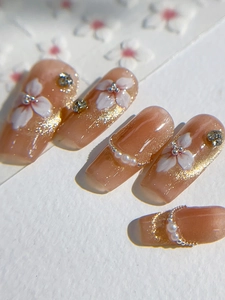 Detail of pink jelly nail stickers with glitter, white flowers, and pearl 3D decorations