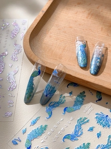 Detail of peacock feather nail stickers with Chinese calligraphy art and glitter accents