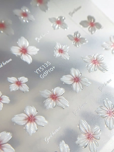 Detailed macro view of 5D embossed cherry blossom nail stickers with 3D floral texture