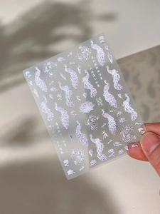Holographic nail sticker detail featuring peacock patterns and Chinese poetic script