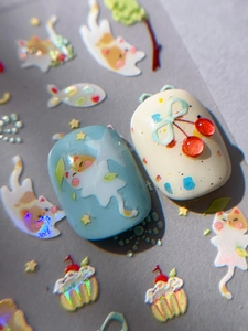 Macro detail of cute cat nail stickers featuring blue bows and laser glitter patterns