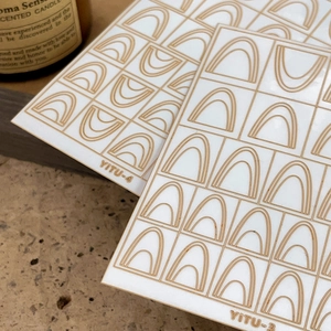 Minimalist french style nail art stickers with brown geometric lines on creamy white background
