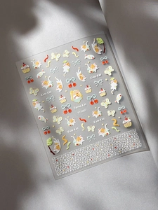 Cute cartoon cat nail art stickers featuring colorful cherry and cupcake patterns