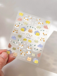 Close-up of cute cartoon cat and dog nail art stickers with silver foil star accents