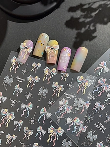 Detail view of 3D embossed nail art stickers with colorful bows, hearts, and floral designs