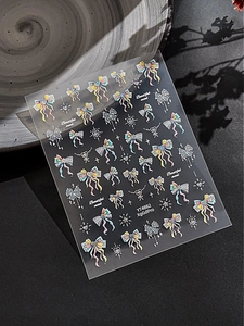 Detail of glitter bow and heart nail art stickers with butterfly and lace patterns