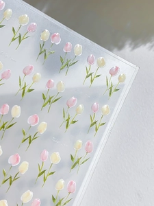 Vue macro de stickers ongles tulipes roses et jaunes avec relief et texture mate
