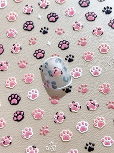 Detailed relief of pink cat paw nail stickers with leopard print on cream leather