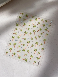 Detailed view of laser palm tree nail art stickers with seagull patterns on light background