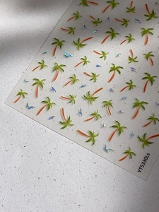 Detailed macro view of laser coconut tree and bird nail art stickers on a grey marble base
