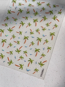Macro detail of holographic coconut palm and seagull nail stickers with laser effect