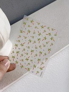 Detail of laser palm tree nail stickers with green leaves and silver reflective glitters