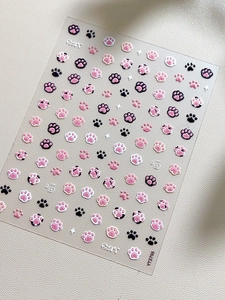 Macro detail of 3D embossed cat claw nail art stickers with relief texture and motifs