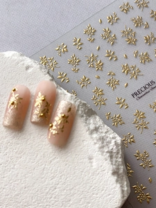 Detailansicht der 3D geprägten goldenen Osmanthus Nagelaufkleber mit fertigen Nagelbeispielen