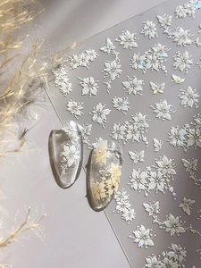 5D floral nail art stickers with white flowers and butterflies shown on clear nails