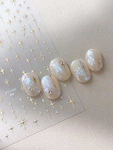 Gros plan d'autocollants étoiles argentées montrant l'effet métallique sur faux ongles