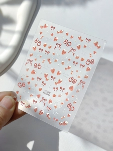 Detail of YT5000 nail stickers with red strawberry, bow motifs and Lucky Baby text