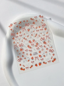 Detail view of strawberry and bow nail stickers with 3D embossed texture on sheet YT5000