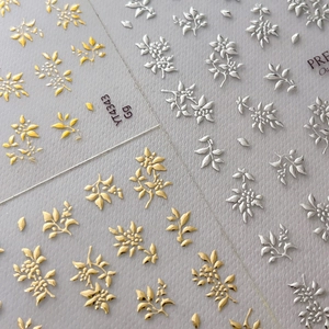3D-Präge-Nagelsticker mit floralem Muster in Gold- und Silber-Metallic auf Grau