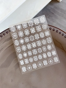 Macro detail of YT4077 embossed white lace nail art stickers with vintage floral patterns