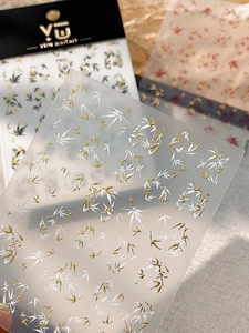 Detail of Chinese style bamboo nail art stickers with gold and red leaf patterns