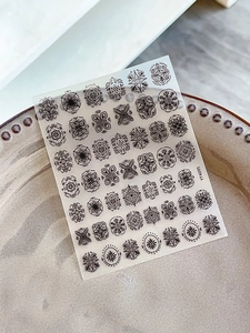 Macro shot of Bohemian mandala nail art stickers YT4095 on a vintage ceramic plate