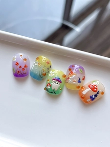 Detail showing 3D mushroom nail art with gradient colors and Adorable text design
