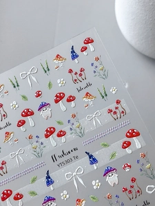 Detailed close-up showing 5D relief mushroom and bow nail art stickers with 3D texture