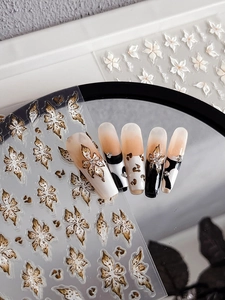 Detail of 3D floral nail stickers with brown leopard print and retro flower patterns