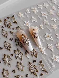 Detailed macro view of 3D embossed floral nail stickers with leopard print and white flowers