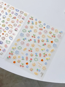 Detail shot of cute cartoon rabbit and bear nail art stickers with colorful fruit patterns