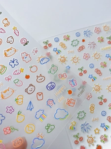 Close-up of cute cartoon rabbit bear and fruit nail art stickers on transparent backing